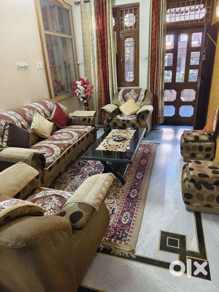 5 seater sofa with two puffy and glass central table