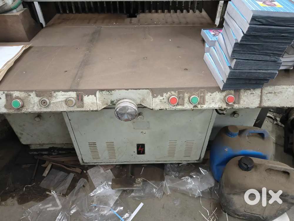 paper cutter, in a workshop or printing facility. 