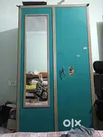 Metallic almirah with Door mirror. Wooden shelf
