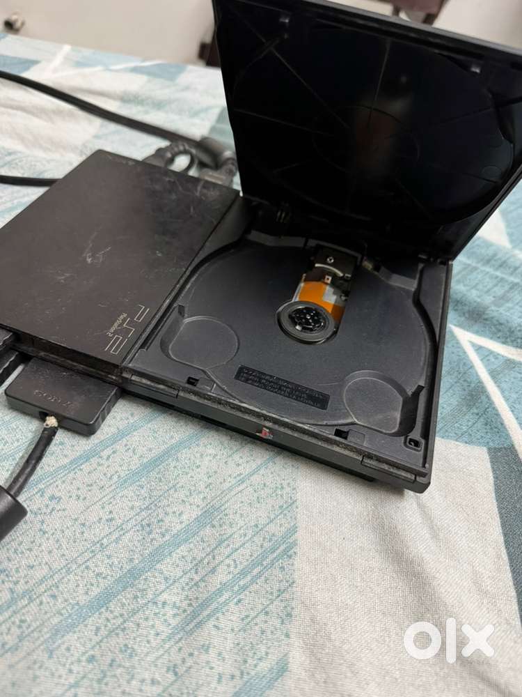 Playstation 2 with game CDs, controller, memory card, adapter