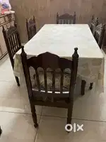 Dining table with six cushioned chairs