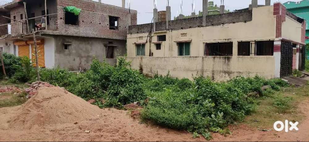 A 60ft roadside residential plot with building for sale