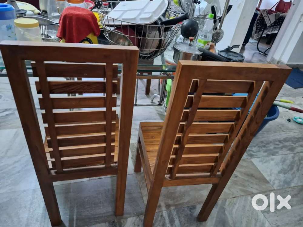 4 teakwood chairs and glass dining table