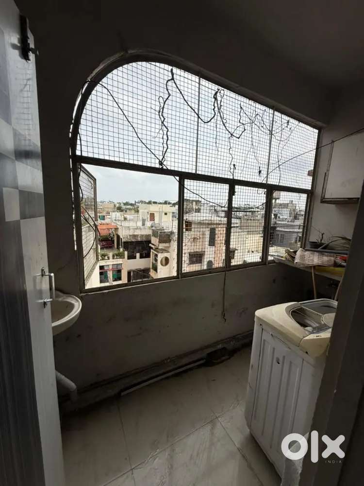 Semi furnished flat with washing machine , ac ,modular kitchen, bed