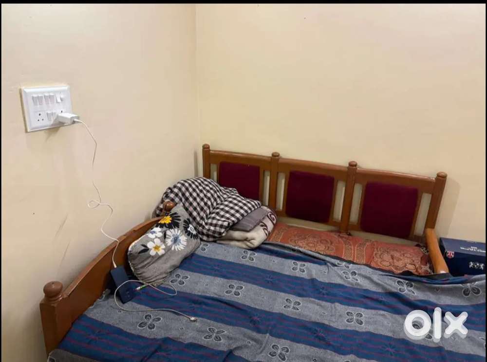 Room wit attache letbath and has bed table one chair fan.