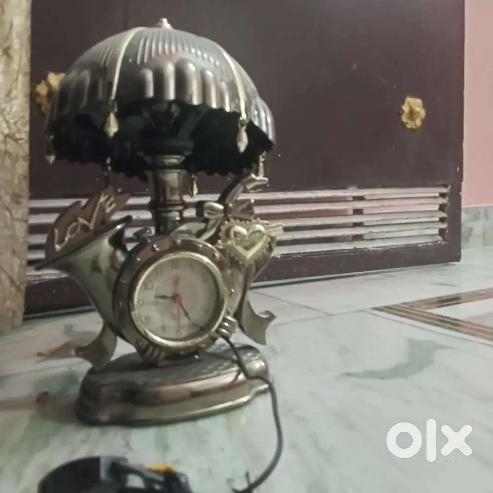 Electric lamp with a bulb cum watch