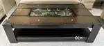 Wooden center table with glass top and artistic design