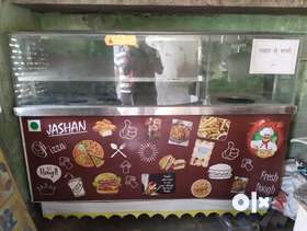 Selling Fast Food L-shape counter , big size in Good Condition, With chair and Big Cupboard Reck , a...