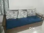 Sofa cum bed and center table