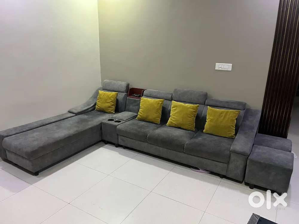 Ash Grey coloured 6 seater L-shaped sofa set with cup holders.