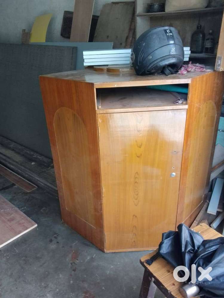 wooden corner cabinet with a drawer and compartment