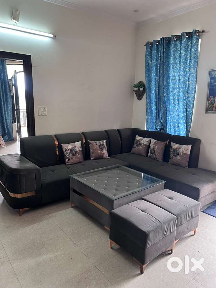 L shape sofa set with glass centre table and 2 extra seats