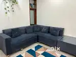 5 seater sofa with glass table and  2 side seaters. Blue-grey coloured