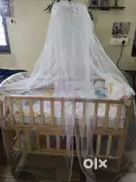 Baby cot with cradle and mosquito net.