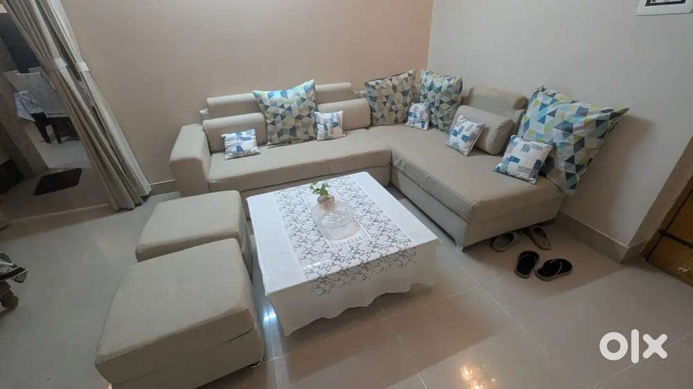 L-shaped sofa set with cover and center table