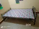 Bed, Tabel, Plastic chair, ceiling fan, 20 L water drum