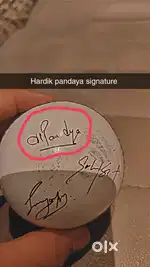 A leather ball signed by Hardik pandaya Shubman gil and one another