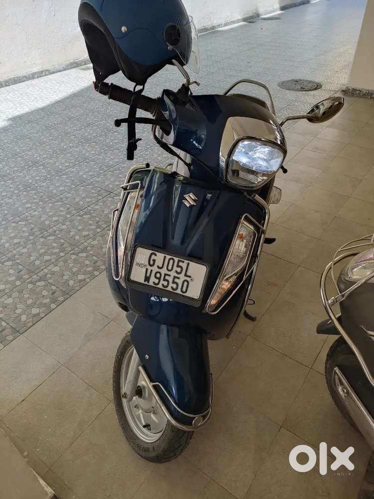 Scooty suzuki access GJ05LW9550 with new helmet