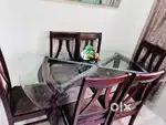 Dinning table with 6 wooden chairs.