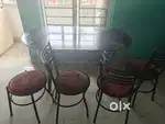 Oval shaped dining table with 3 chairs