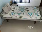 An eligant single saak wood bed with mattress