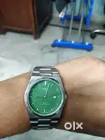 Watch with green dial and date calendar
