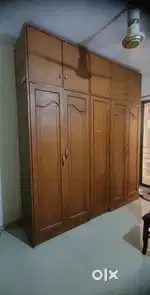 wardrobe with dressing table and top shelfs. It is having a mirror