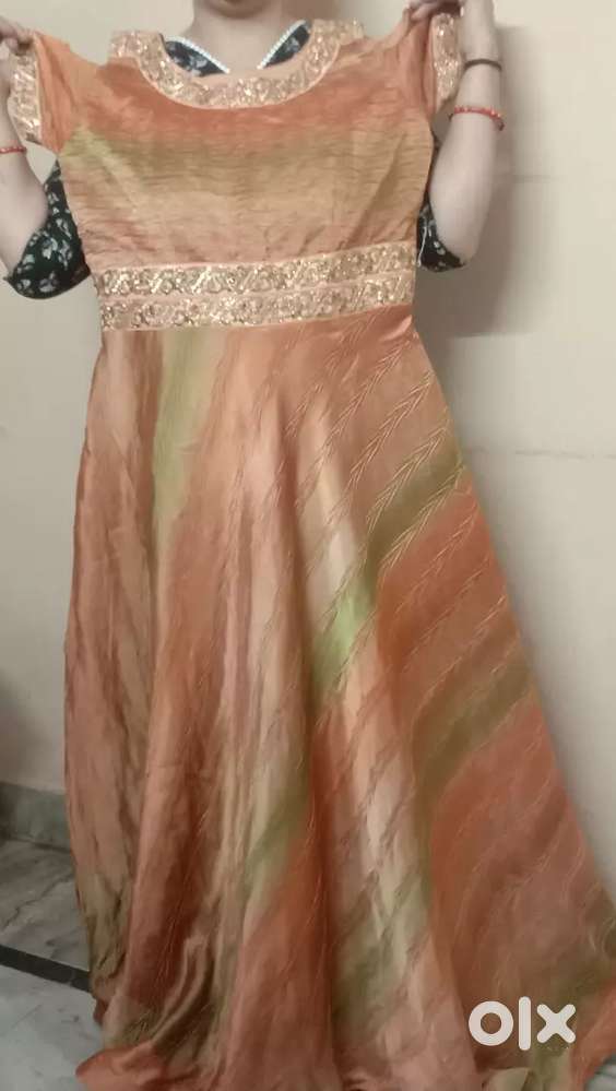This is a very beautiful lehenga in orange colour with green shade