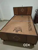 Wooden bed with box storage facility