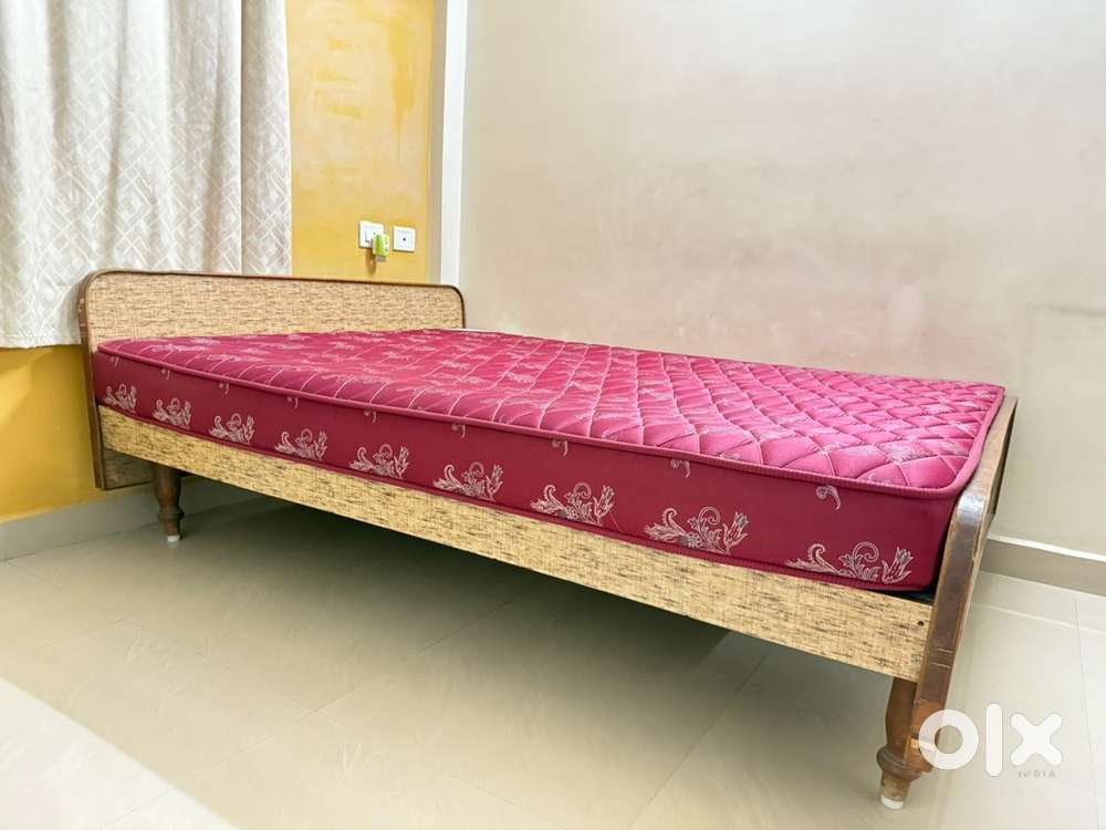 Wooden cot with kurl on mattress