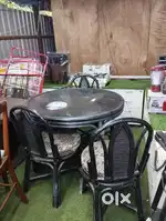 Round Dark-colored Dining Table With Four Chairs (D8) On Rent