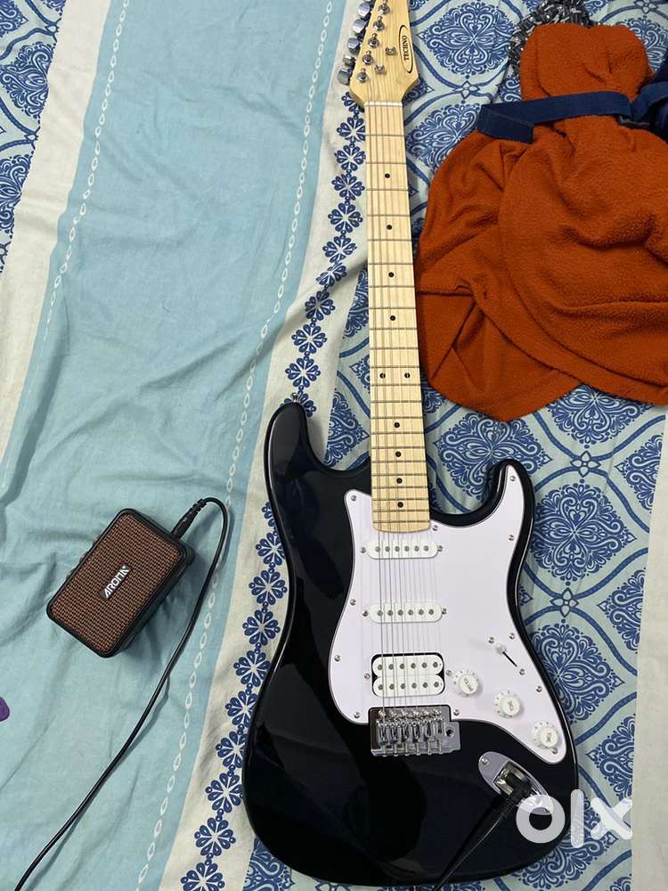 Techno brand new electric guitar with stand and amplifier