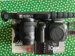 Canon EOS 90D DSLR camera with 18-135mm lens and Sirui monopod