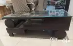 Wooden center table with glass top in good condition.