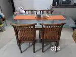 Wooden dining table with glass top and chairs