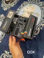 Poloroid camera with cover and instant photo