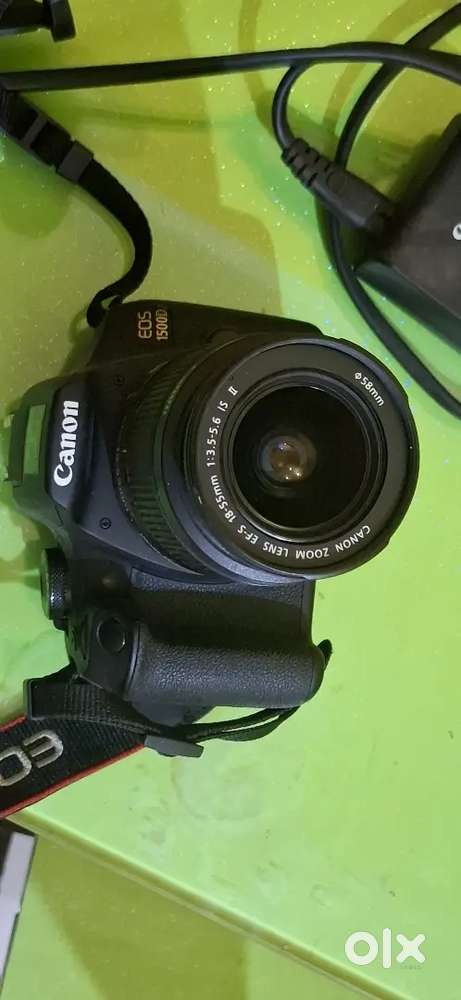 The image displays a Canon EOS 1300D DSLR camera with an 18-55mm