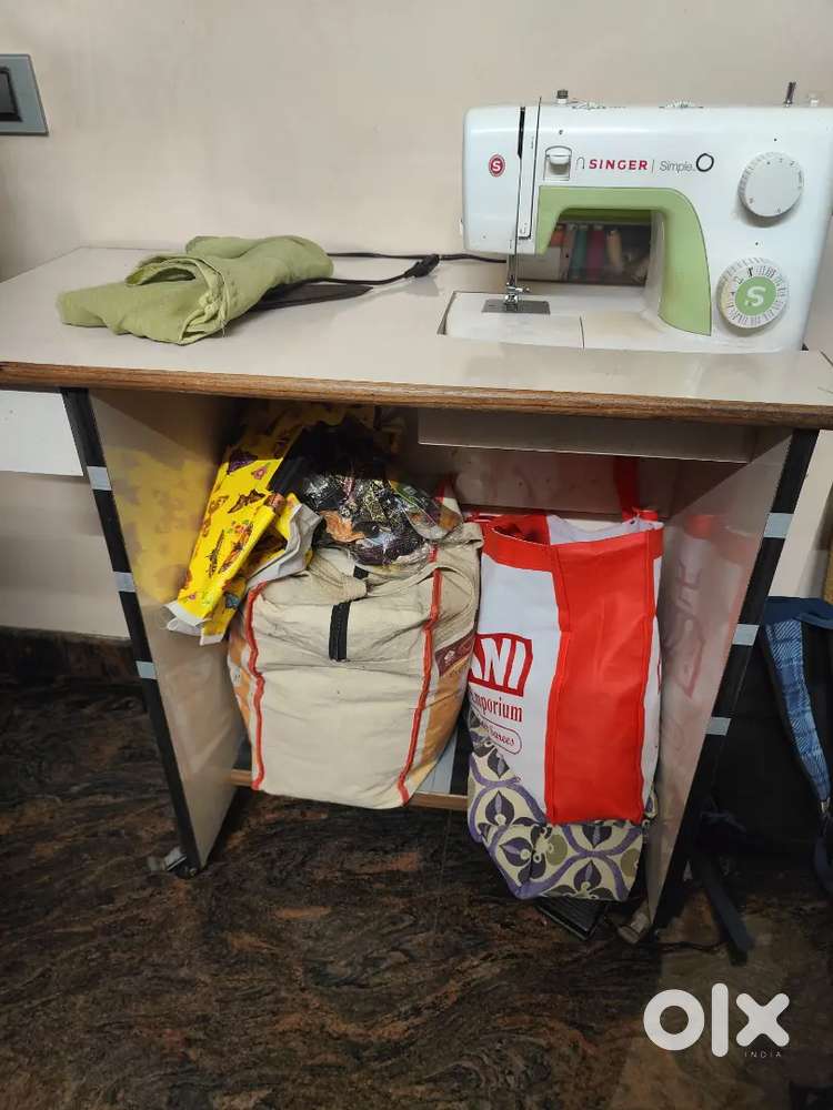 Sweing meachine with table it's in good condition 3yrs old with table