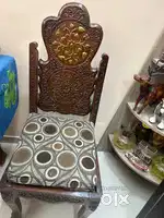 carved wooden dining table with four chairs