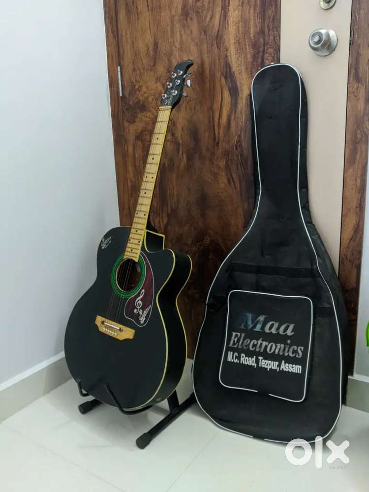 Acoustic Guitar with metal stand and black cover