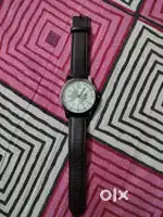 Titan silver dial watch with quartz movement and date function.