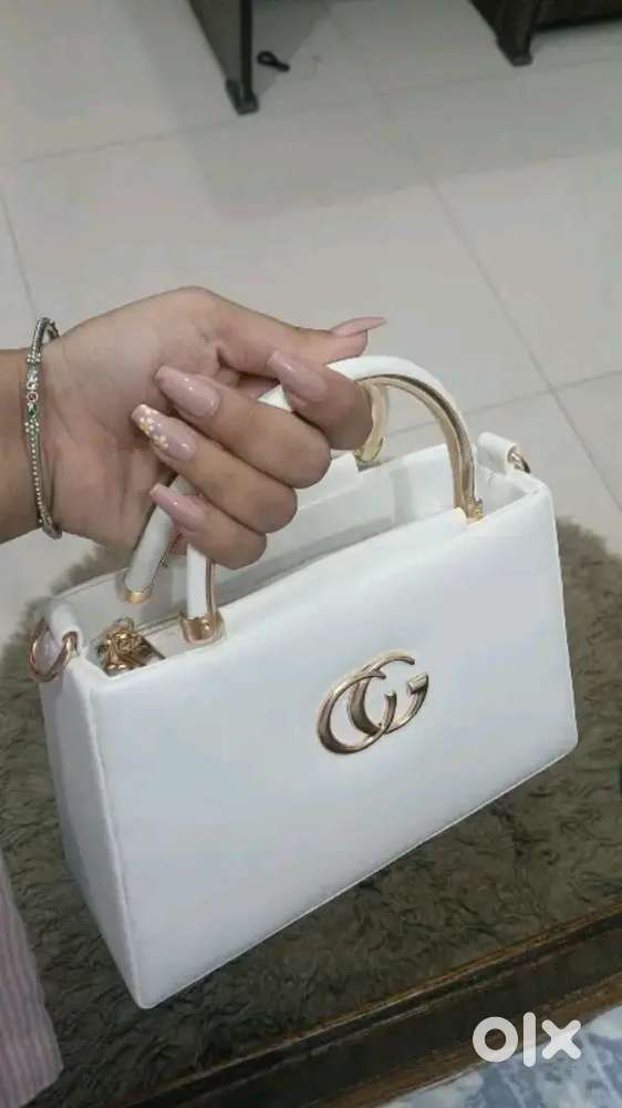Designer Handbag with gold accents and detachable strap