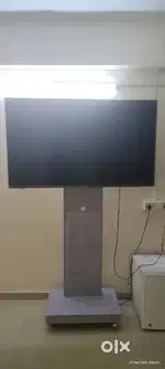 TV Stand with adjustable height and wheels for easy movement.