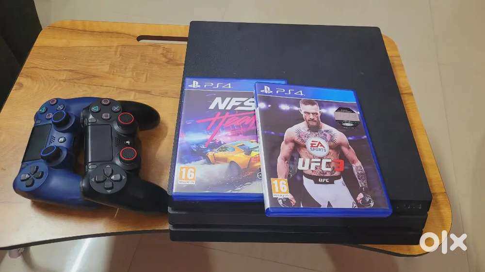 PS4 Pro  2 Original Controllers  2 Game CDs  1 Year PS Plus Deluxe