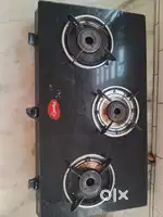 Black glass top stove with three burners