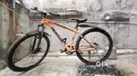 A classic orange colour bicycle.  Usa model fantom with double disc.