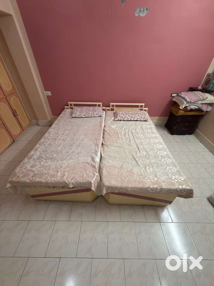 Two single beds with mattresses