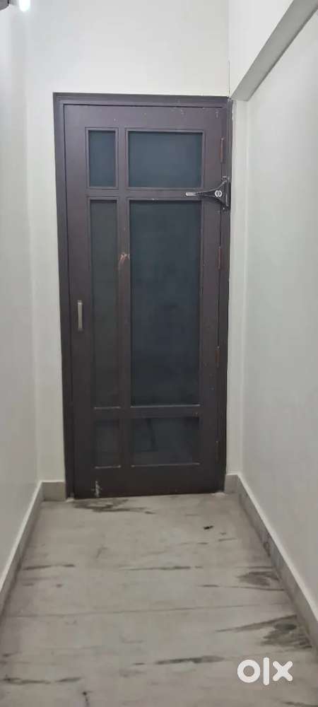 One room with attached kitchen and bathroom. Open space behind