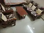 Wooden sofa set with a center table