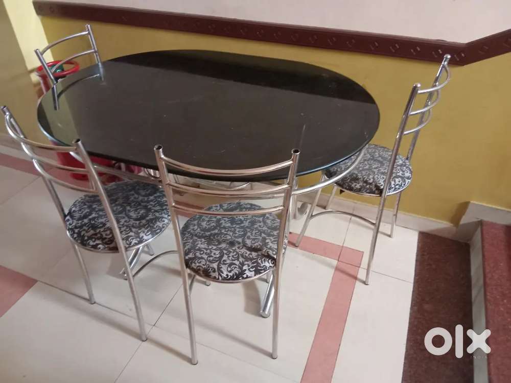 Owel shape glass top dining table with 4 chairs